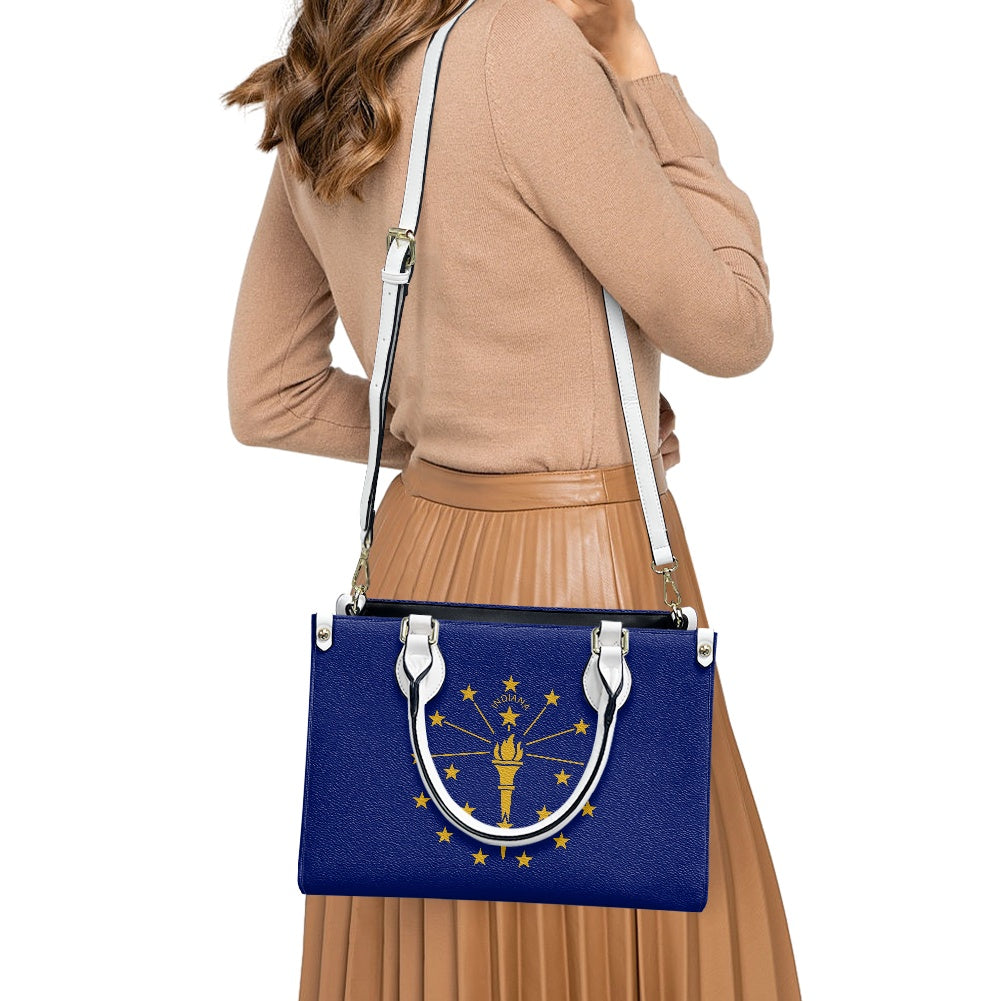 Woman carrying [Brand] handbag with Indiana flag design.