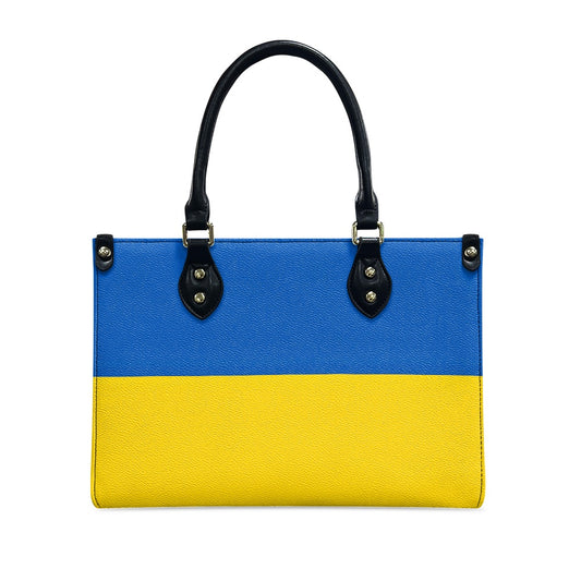 [Brand] handbag in blue and yellow with black handles.