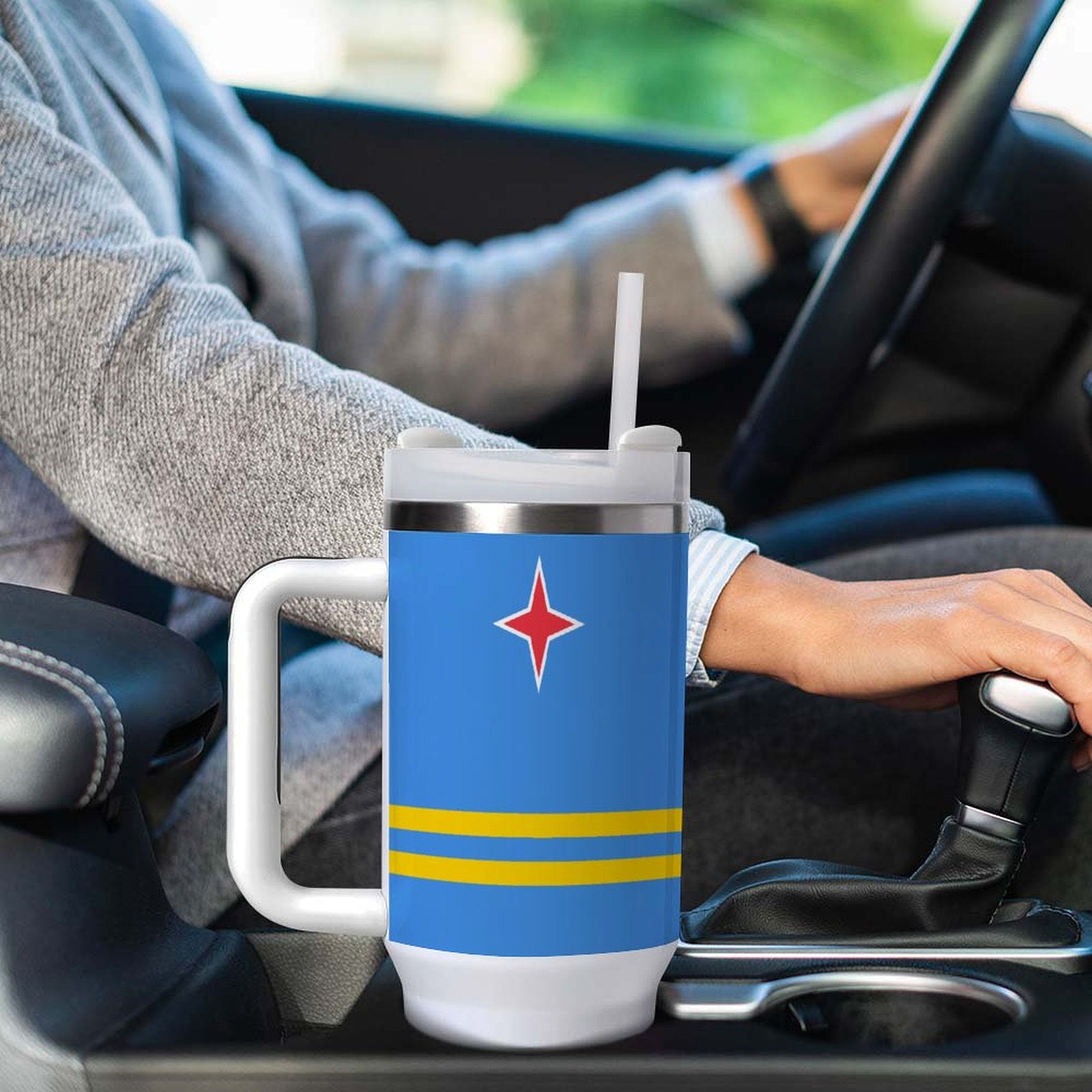 Person driving car with [Brand] mug in holder.
