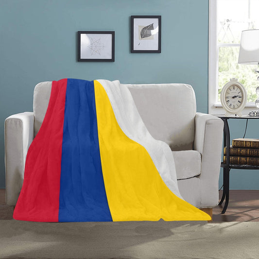 Cozy sofa with Luv My Flag striped blanket draped.