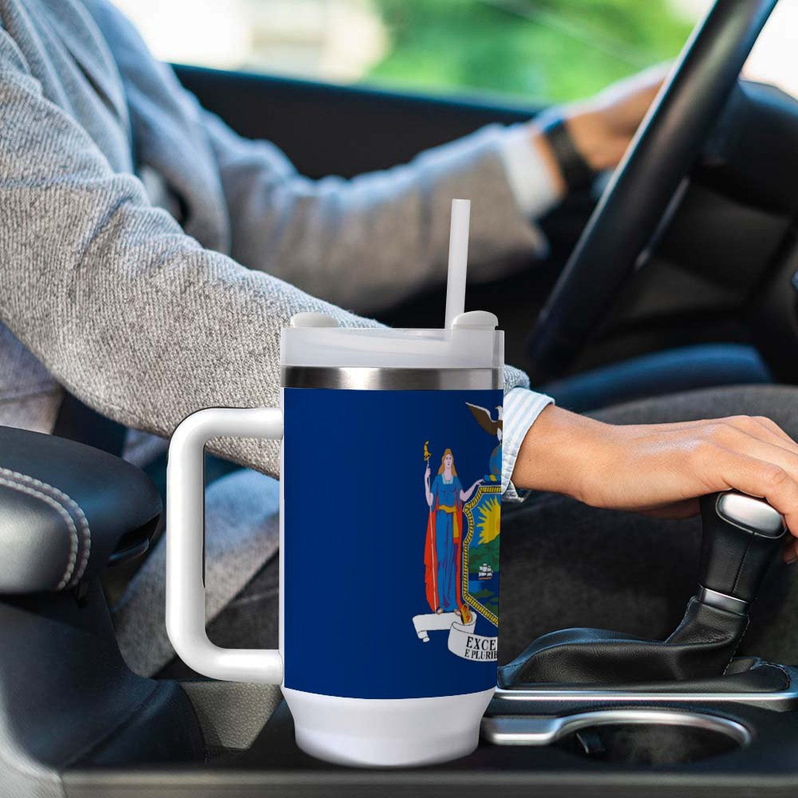 Driver holds [Brand] mug with state flag design.