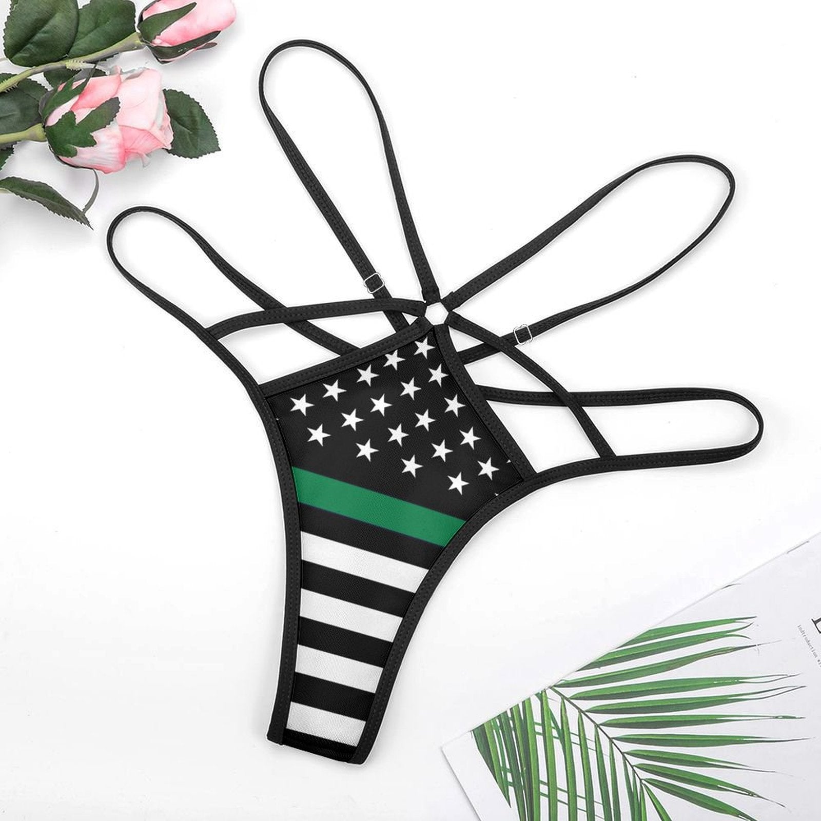 [Brand] black strappy thong with American flag design.
