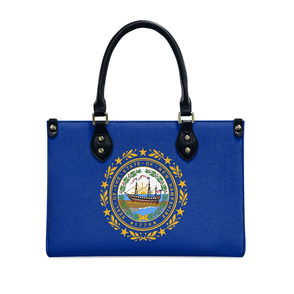 Blue handbag featuring New Hampshire seal, black handles, [Brand].