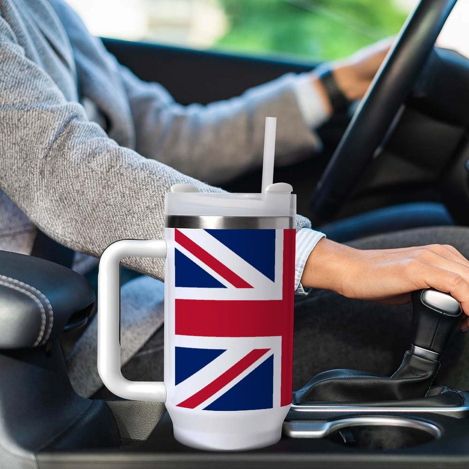 [Brand] mug with British flag design in car's cup holder.
