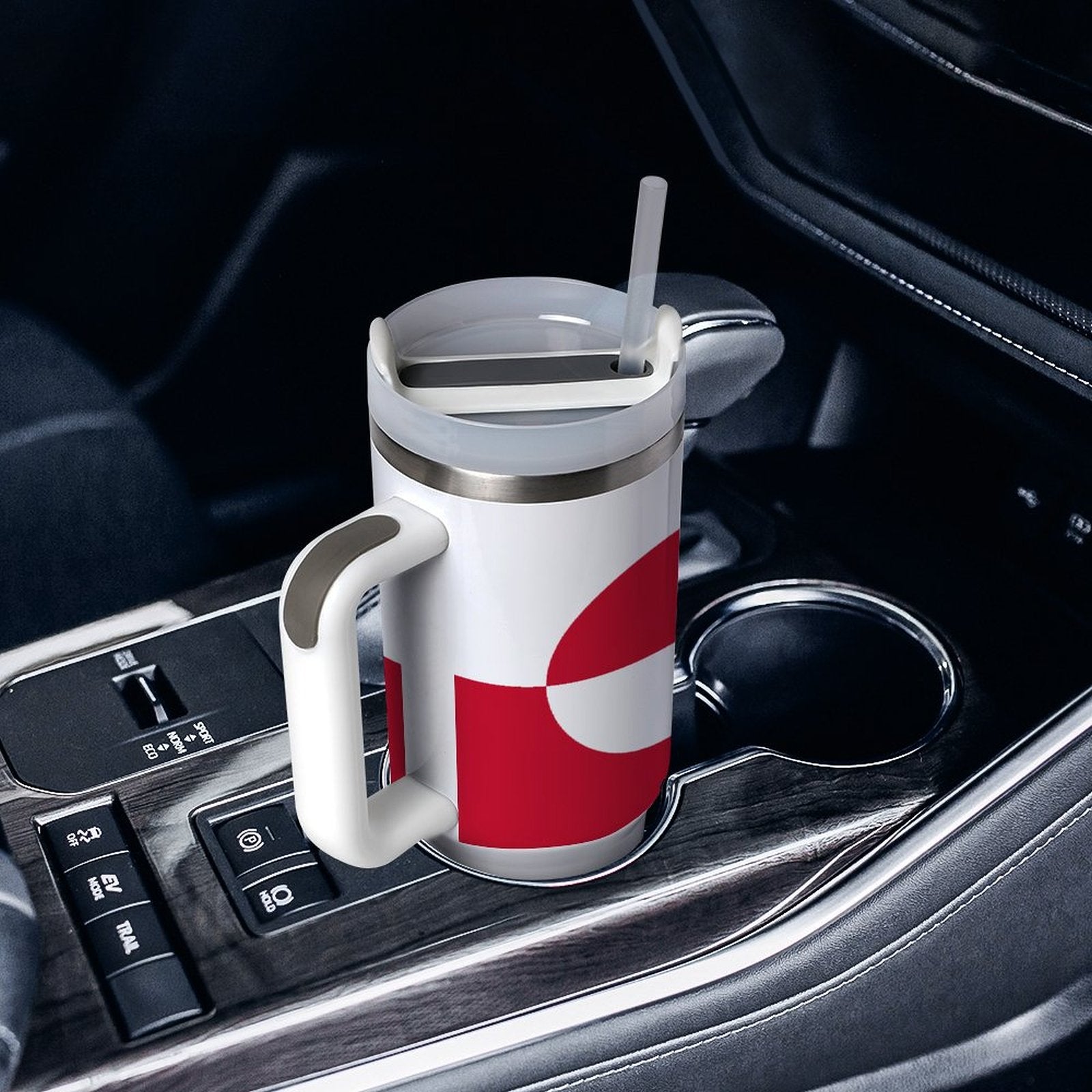 [Brand] travel mug with handle in a car cupholder.