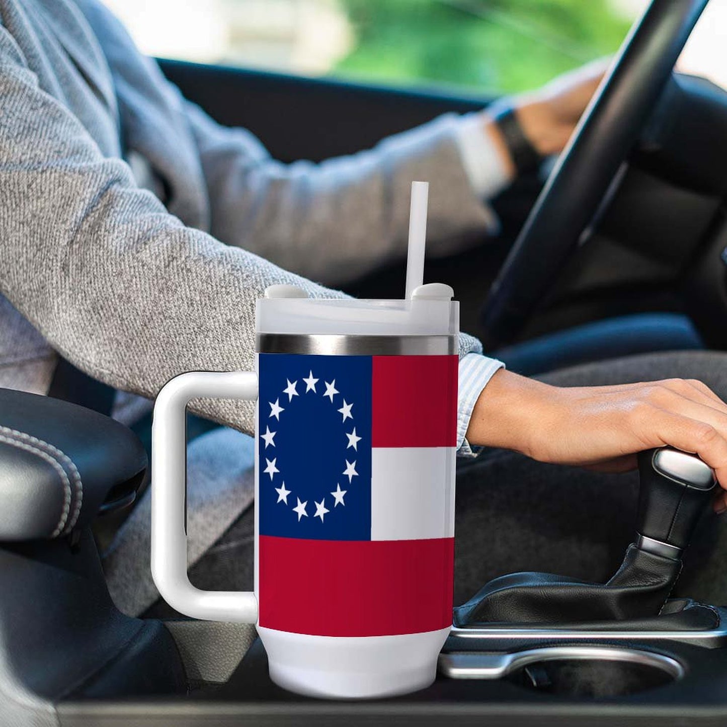 [Brand] mug with flag design in car cup holder.