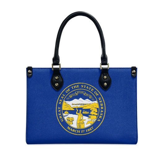 Blue handbag with Nebraska state seal, by [Brand].