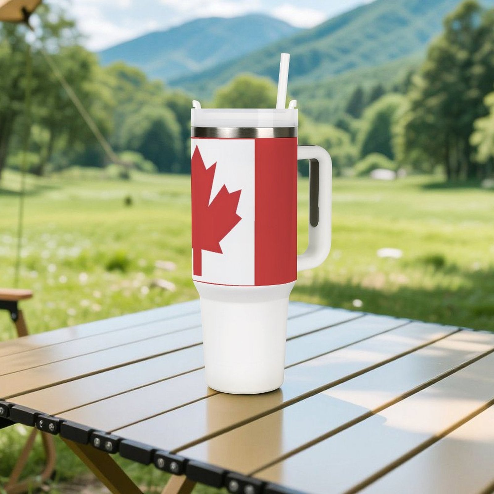 [Brand] travel mug with Canadian flag on picnic table.