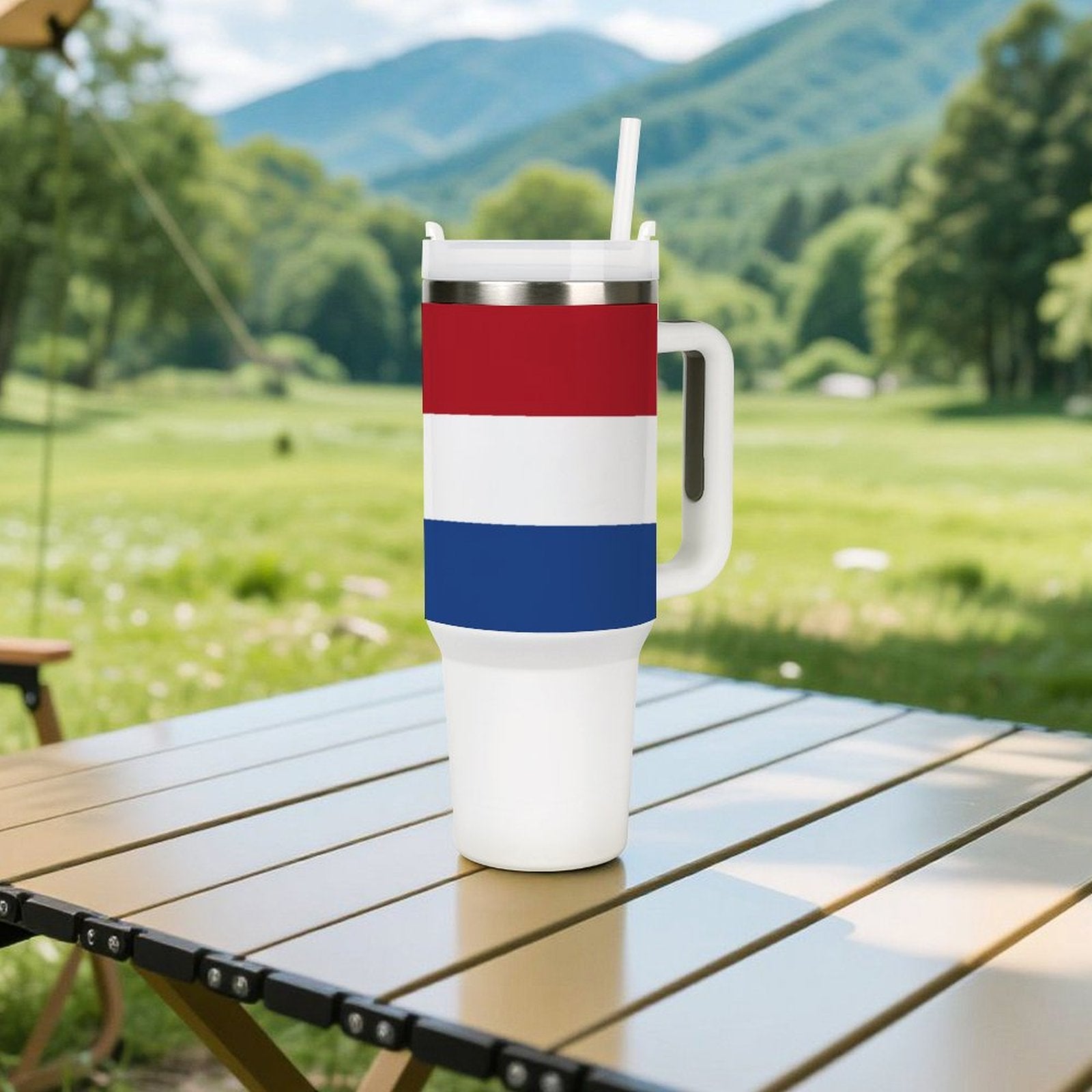 Outdoor scene with a [Brand] tumbler on wooden table.