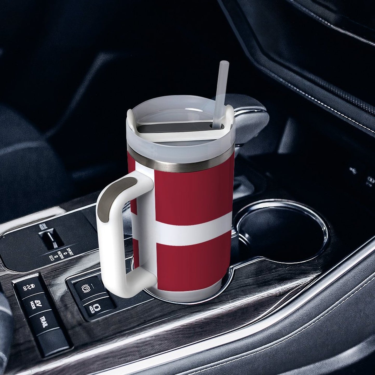 [Brand] travel mug with straw in car's cup holder.
