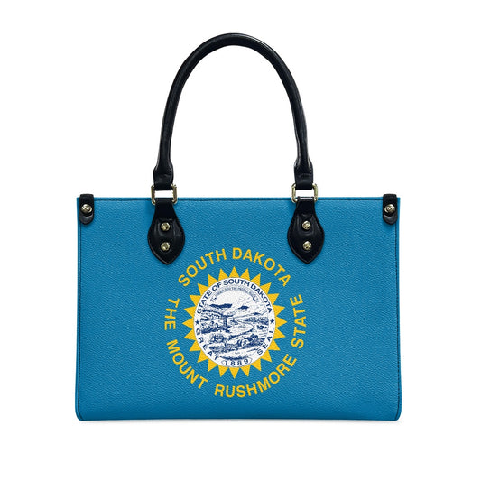 Blue [Brand] handbag with South Dakota emblem and handles.