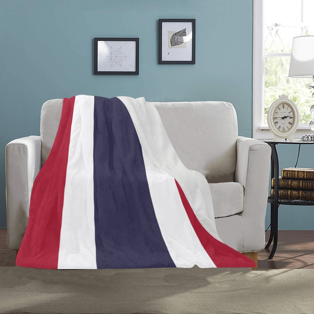 Luv My Flag blanket draped over sofa in cozy room.