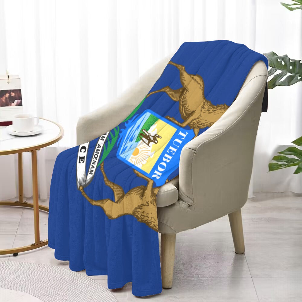 A blue "Luv My Flag" blanket on beige chair.