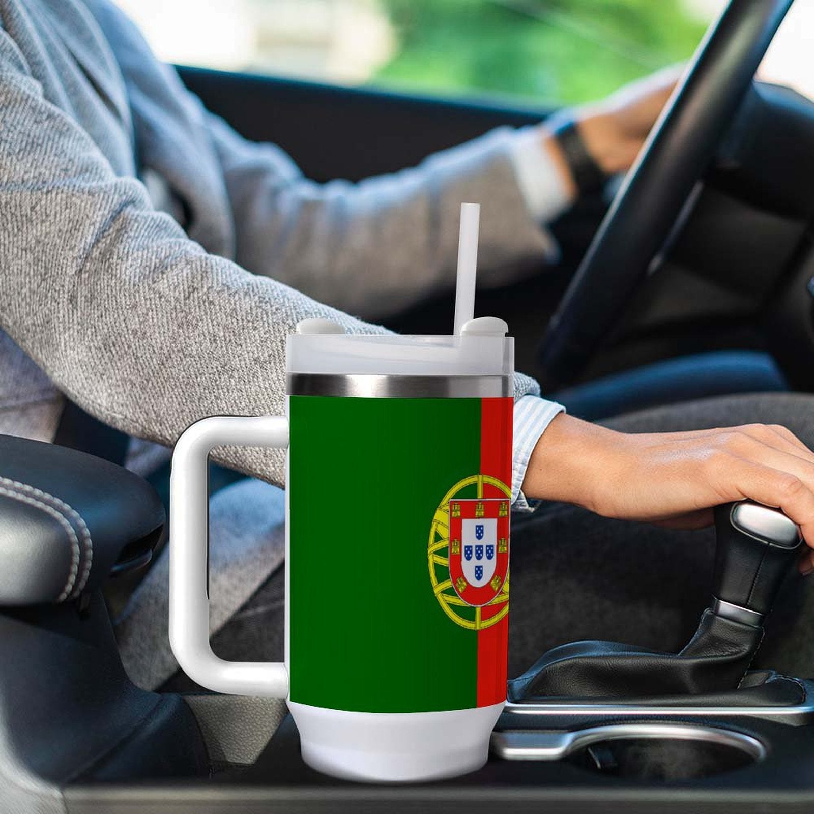 Person driving with [Brand] mug featuring Portuguese flag design.