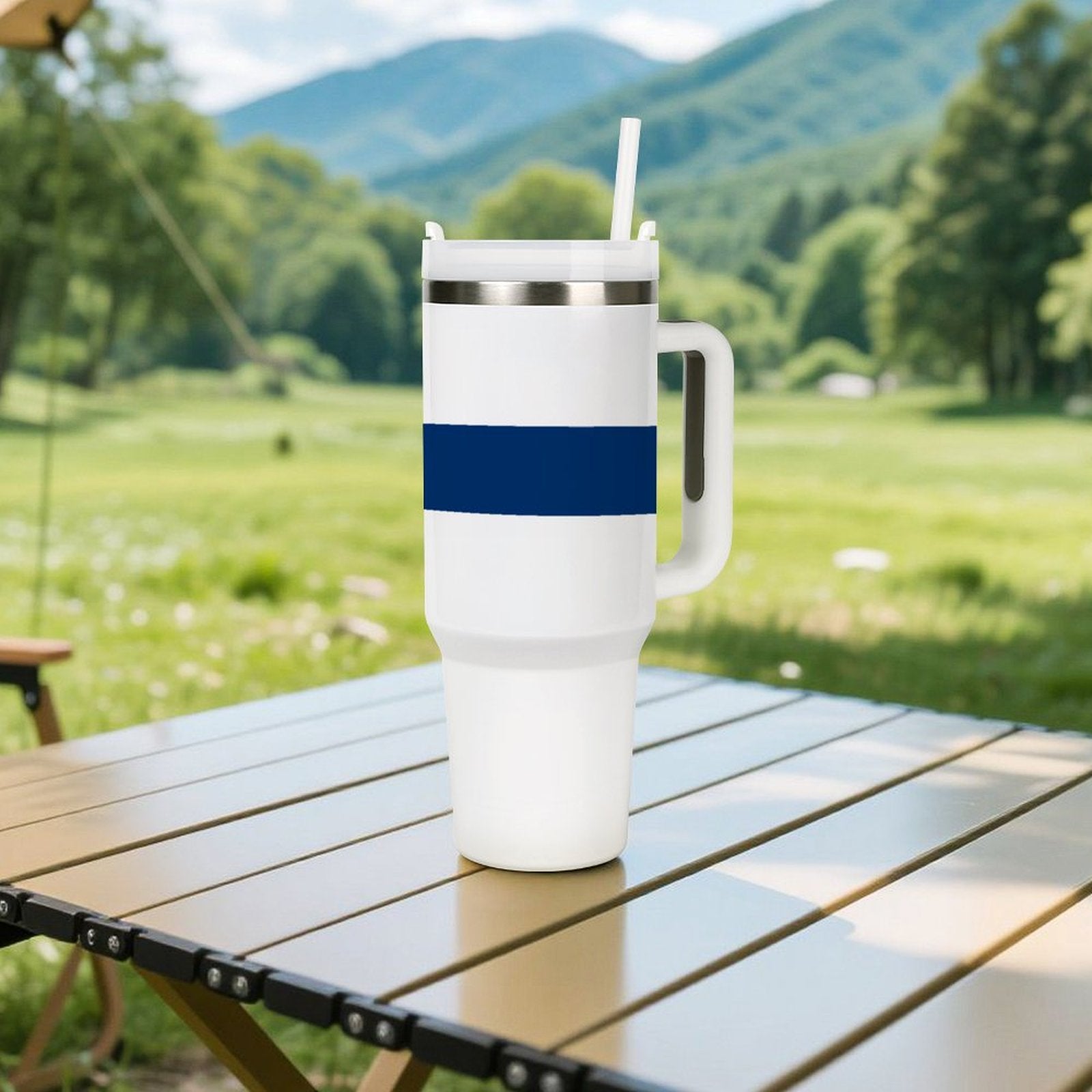 [Brand] tumbler on outdoor table, mountains and trees background.
