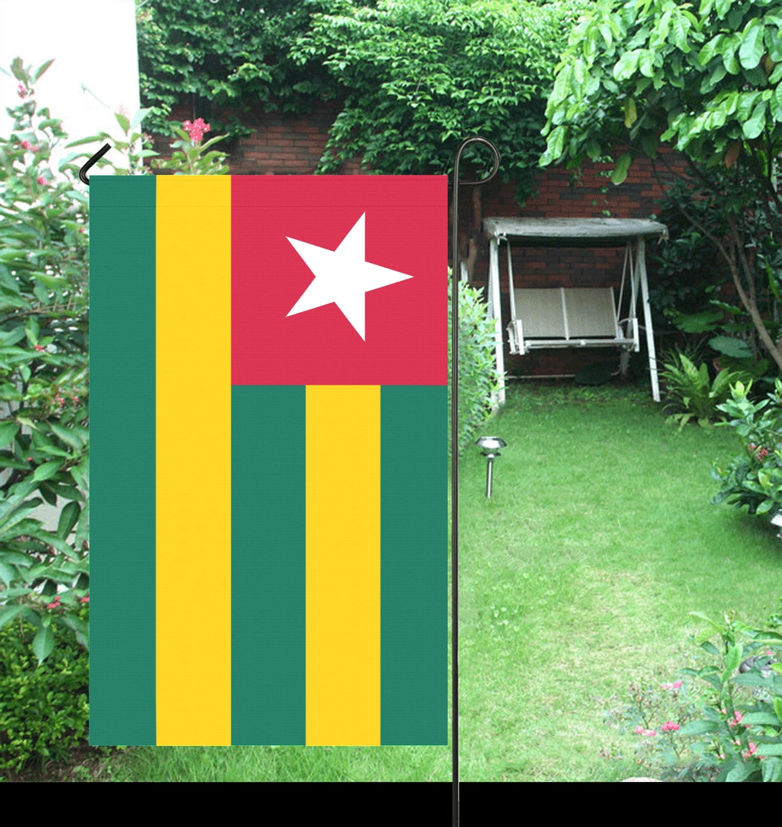 Luv My Flag: Togo flag displayed in lush garden.