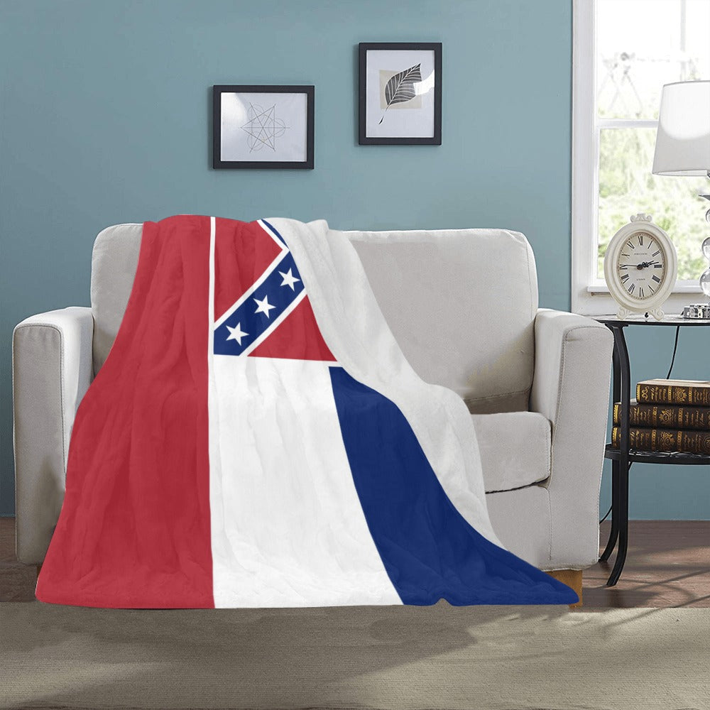 Soft blanket with [Luv My Flag] design on white sofa.