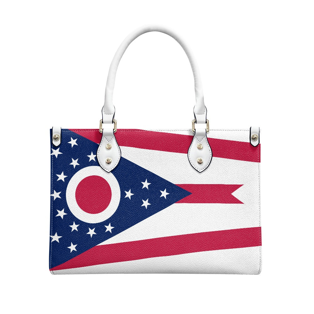 [Brand] handbag featuring Ohio flag design with white handles.