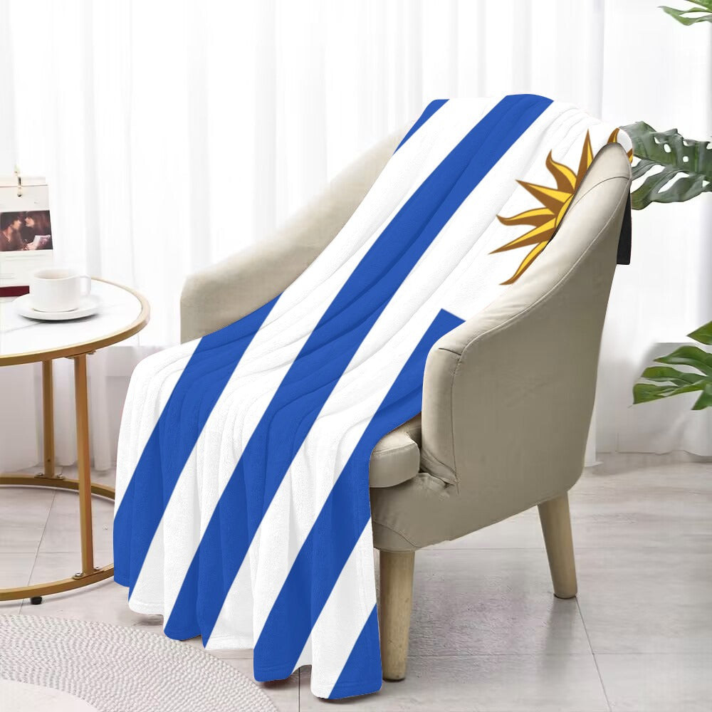 Luv My Flag blanket drapes over chair with sunlight.