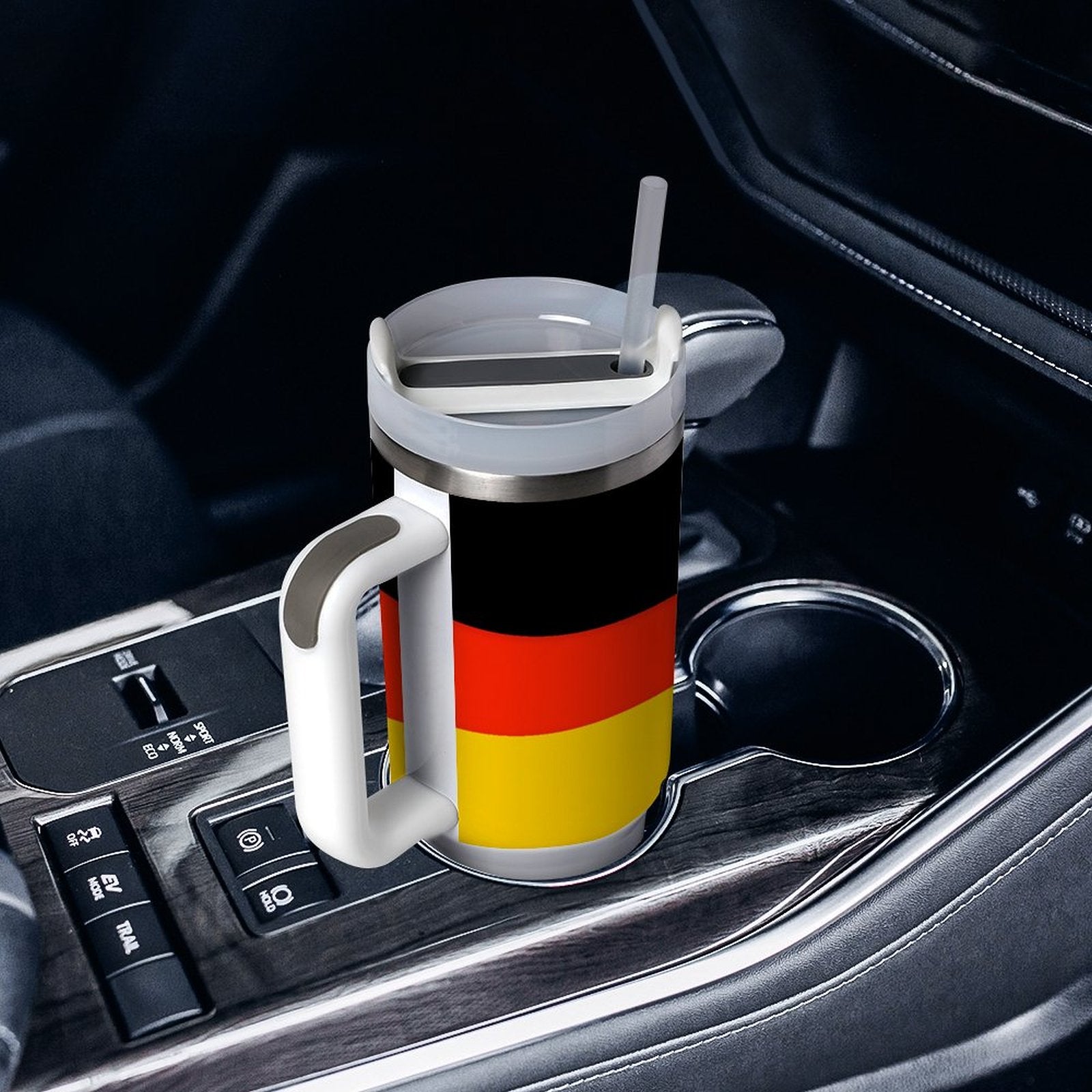 [Brand] travel mug with German flag in car holder.