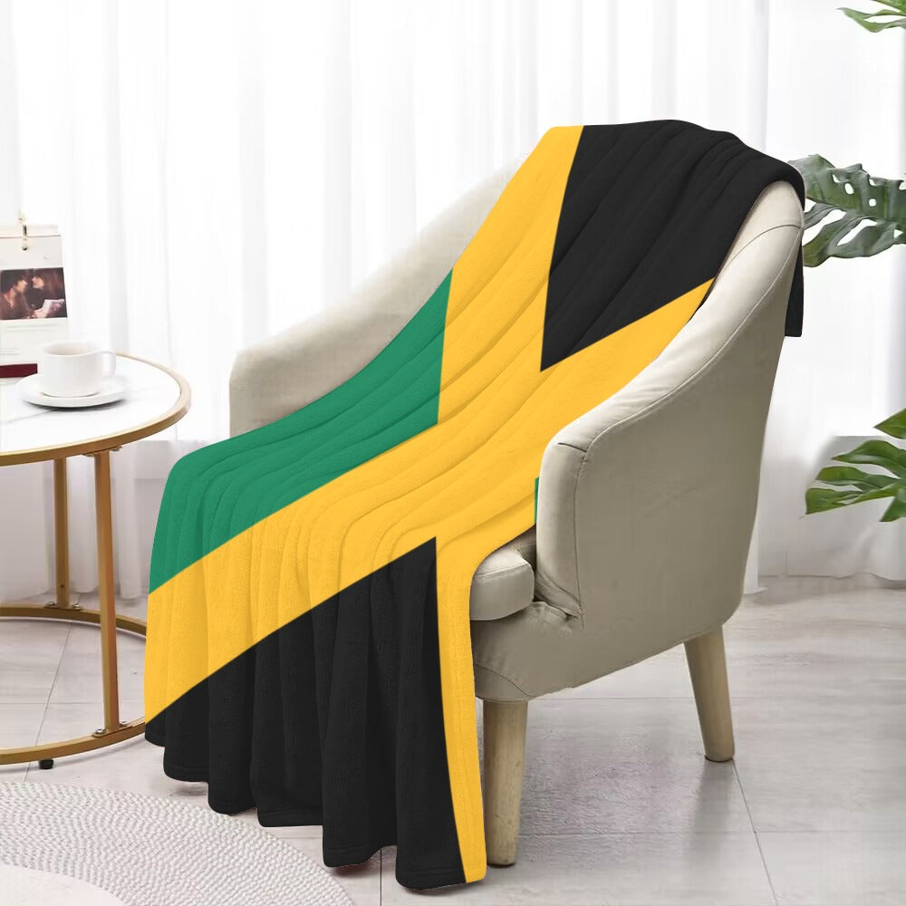 Soft chair with Luv My Flag Jamaican-themed blanket draped over.