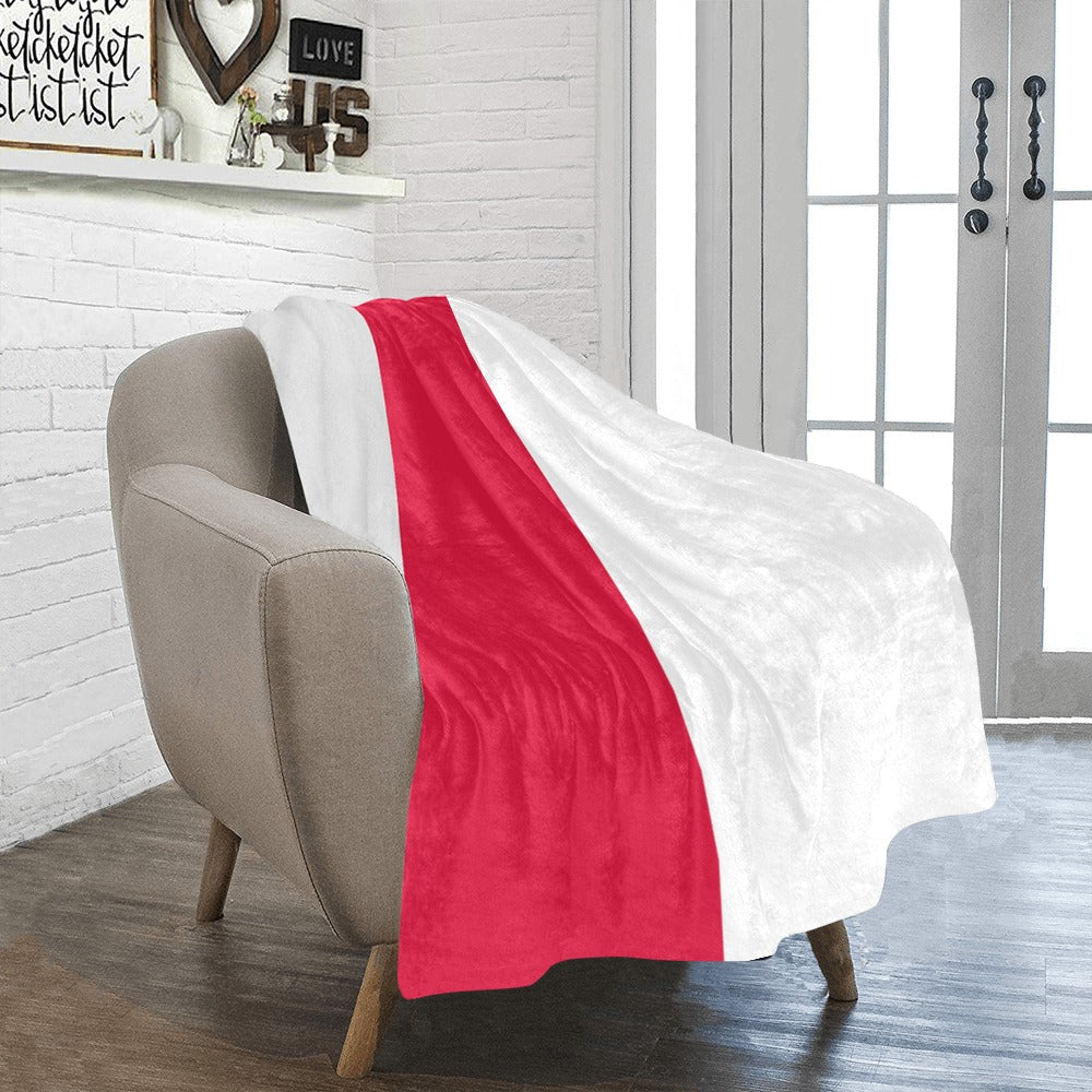 Cozy chair draped with Luv My Flag's red-white blanket.