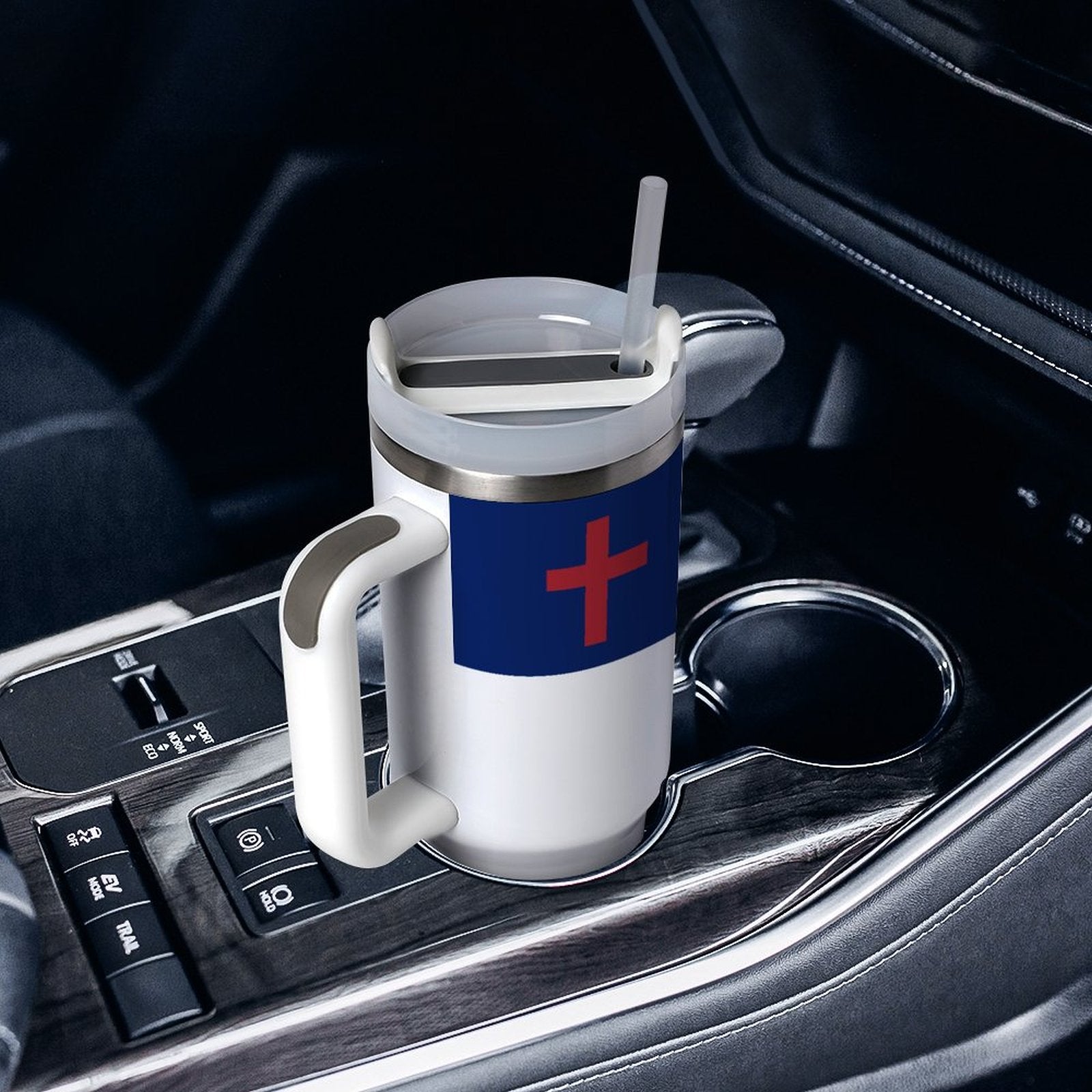 [Brand] mug with straw in a car cup holder.