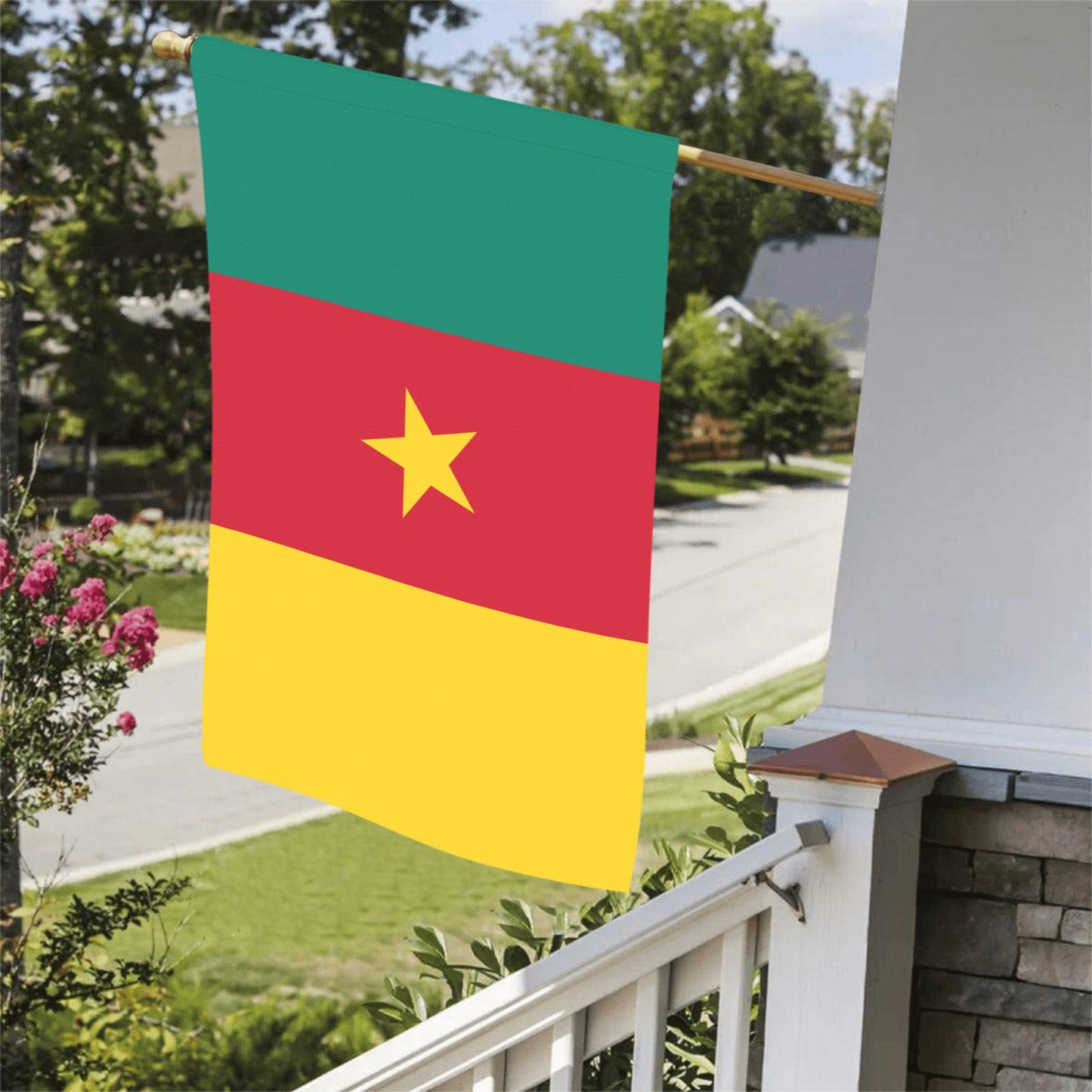 "Luv My Flag's Cameroon flag displayed on porch railing."