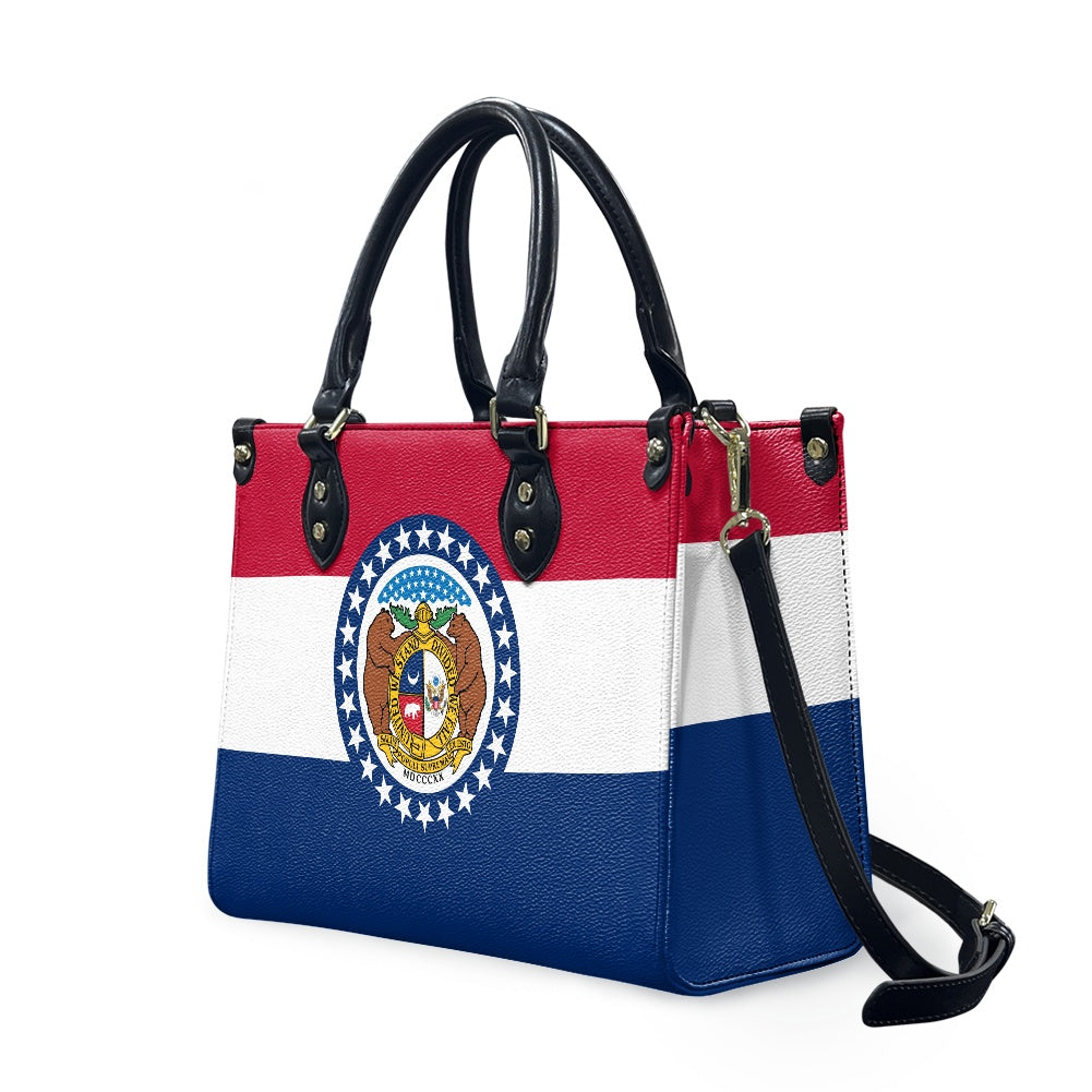 [Brand] handbag featuring Missouri state flag design, black handles.