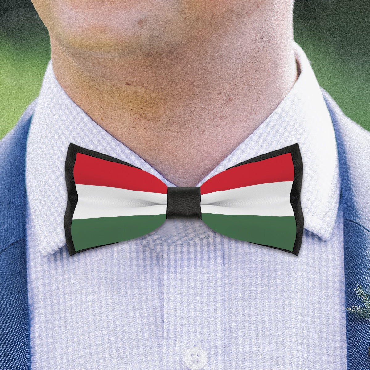 Man wearing [Brand] bow tie with red, white, green stripes.