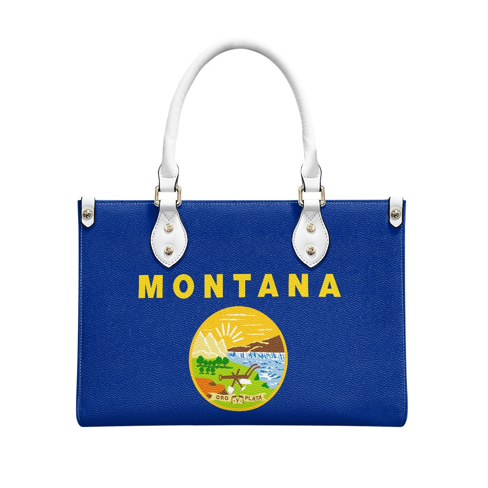 [Brand] blue handbag with Montana design and white handles.