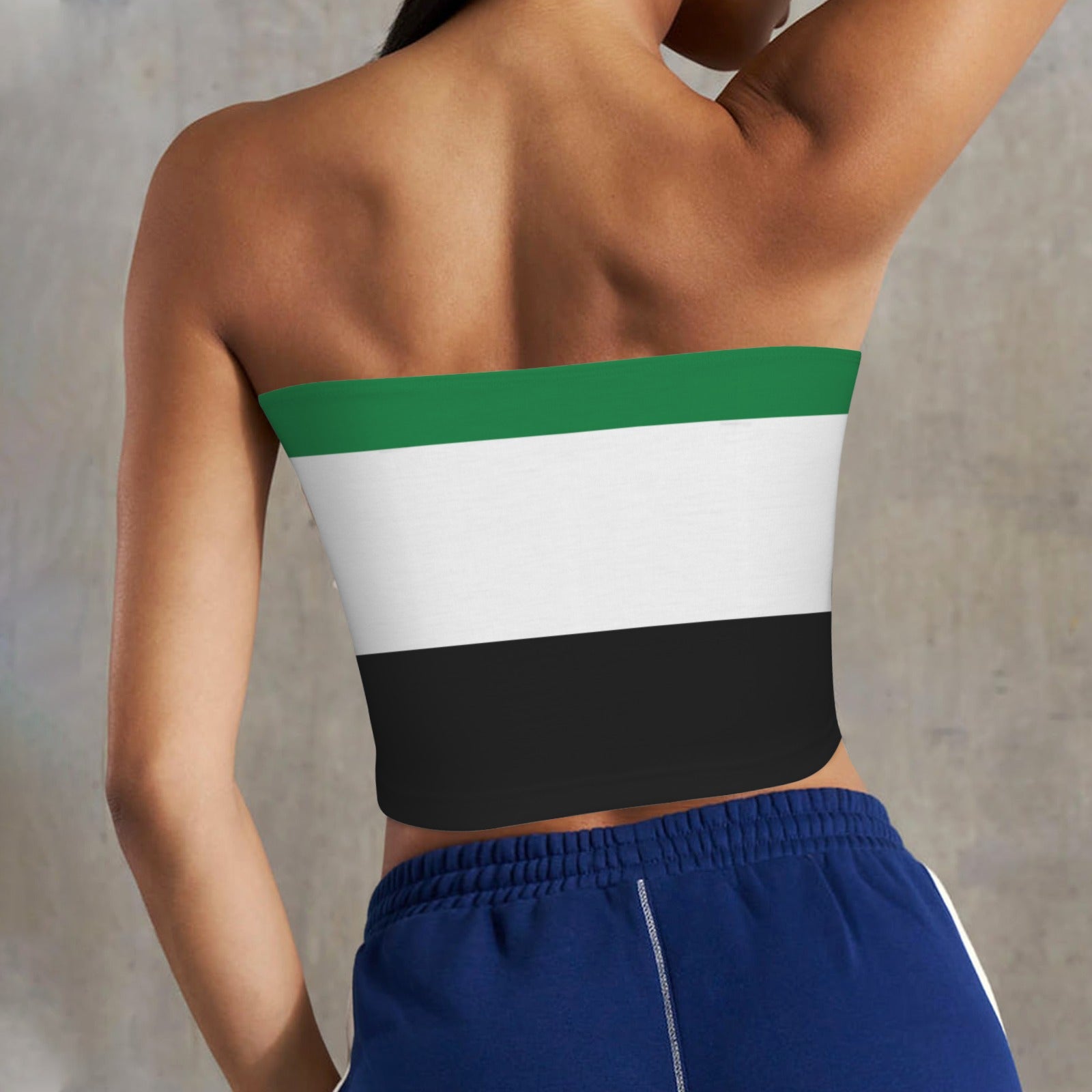 Person wearing [Brand] strapless top with tricolor design.