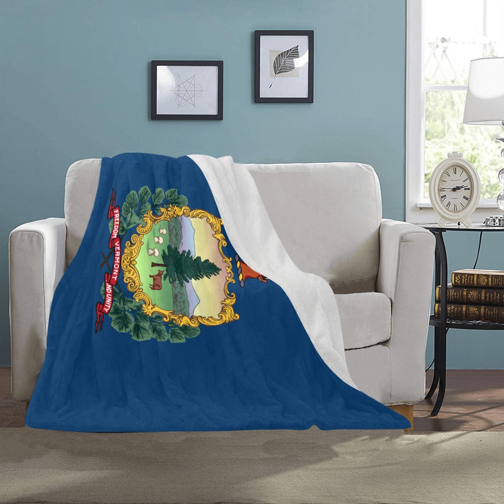 [Luv My Flag] Vermont-themed blanket draped over white sofa.