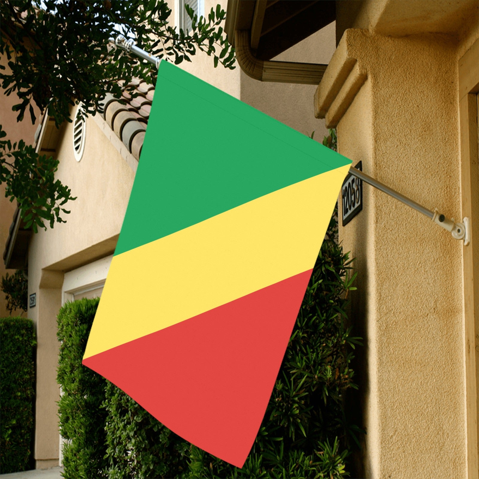 Luv My Flag brand African flag displayed outside beige building.