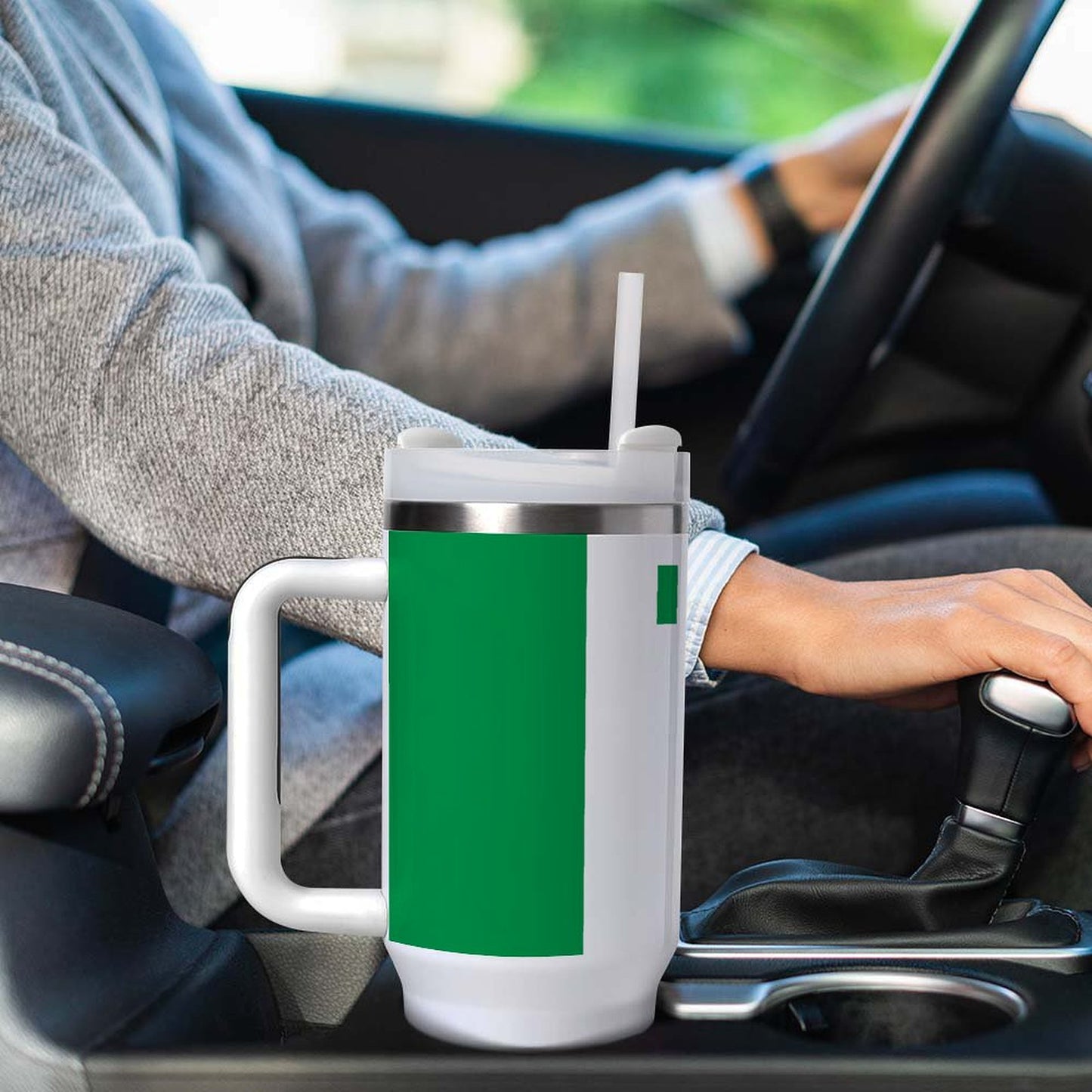 Person driving with large [Brand] mug in cup holder.