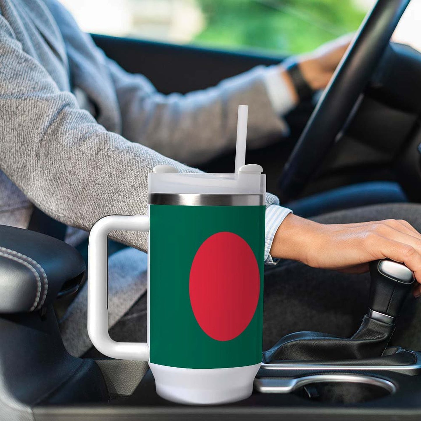 Person driving with [Brand] mug in car cup holder.