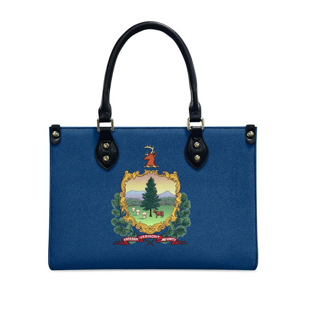 Blue [Brand] handbag with Vermont state emblem design.