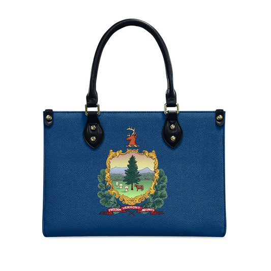 Blue [Brand] handbag with Vermont state emblem design.