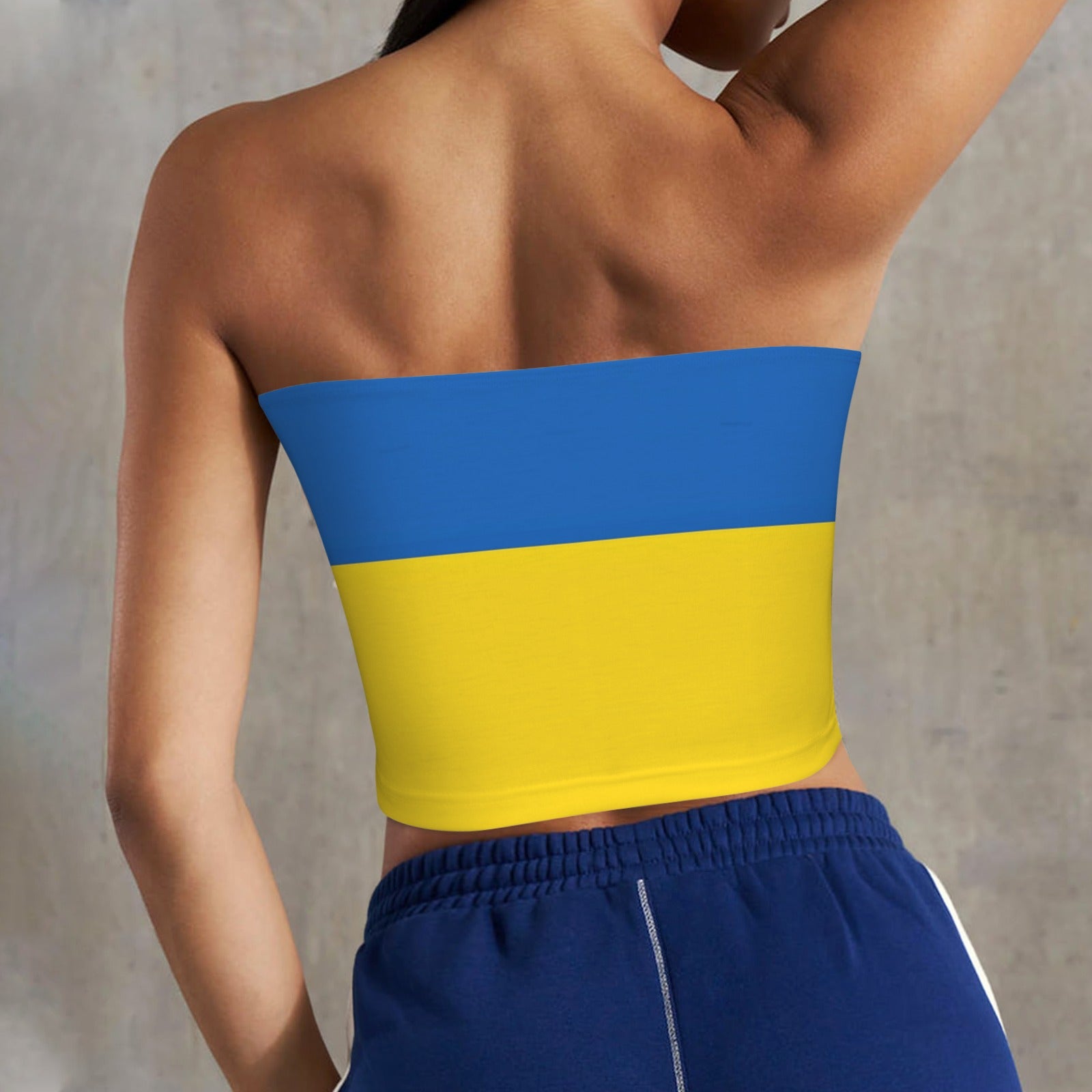 Back view of woman wearing [Brand] blue and yellow top.