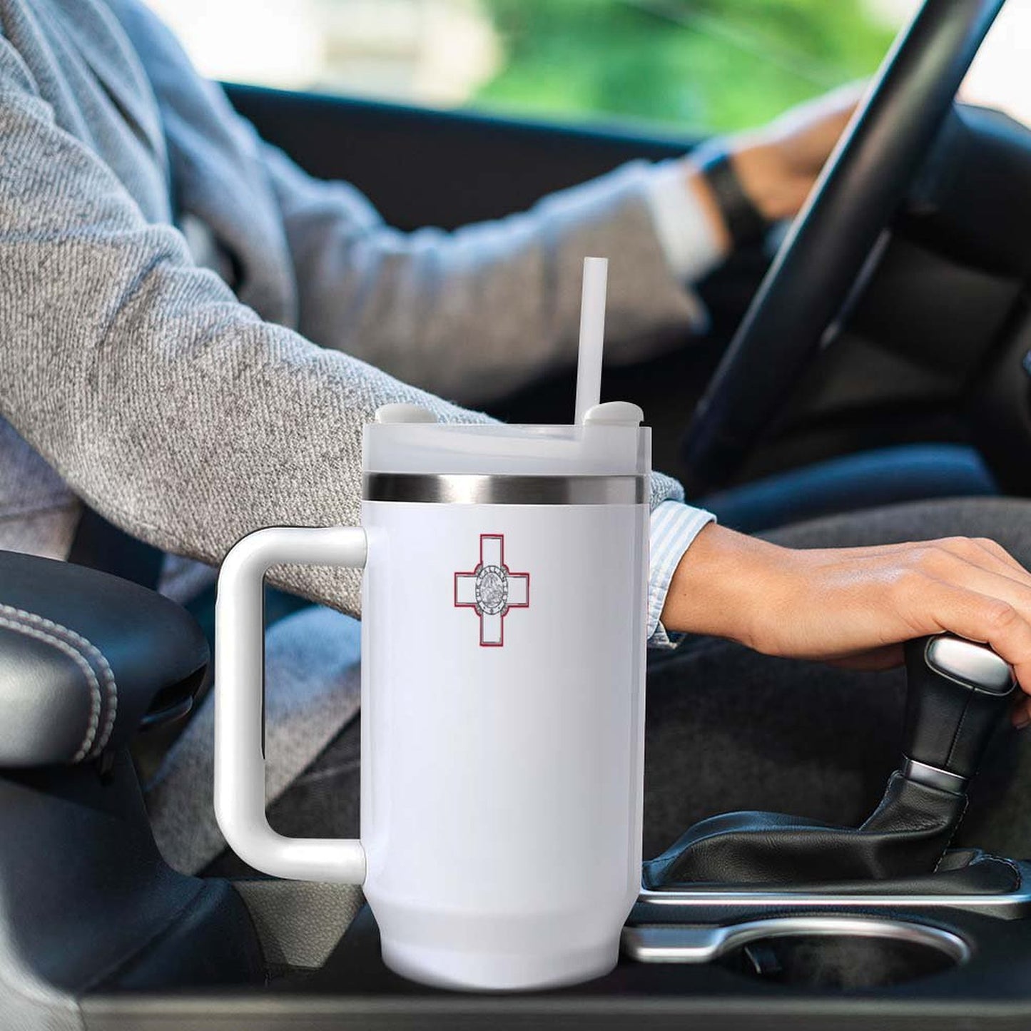 Person driving car with large [Brand] mug in holder.