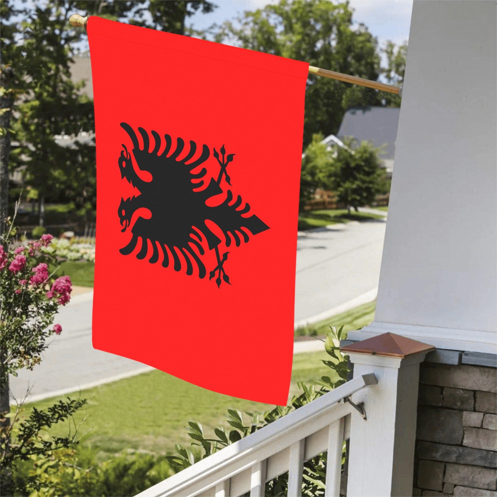 Red flag with black eagle, displayed outside. [Luv My Flag]