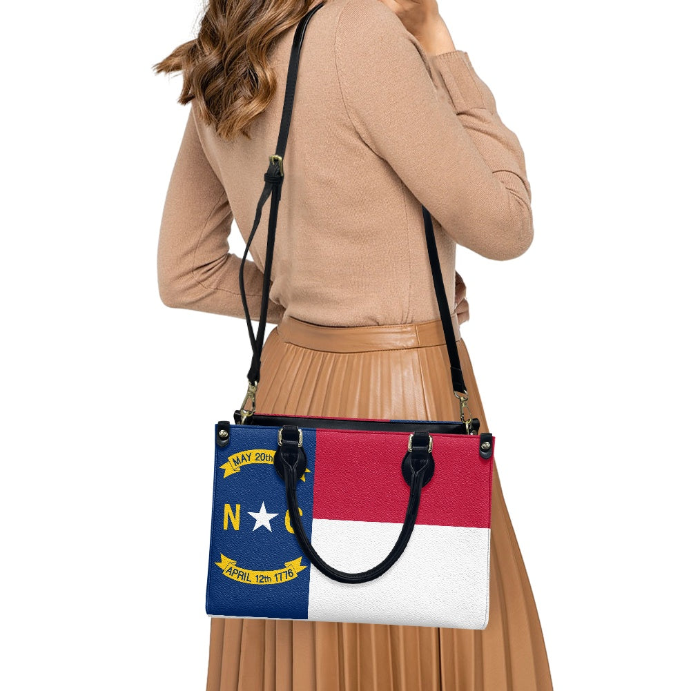 A woman carries a [Brand] bag with North Carolina flag.