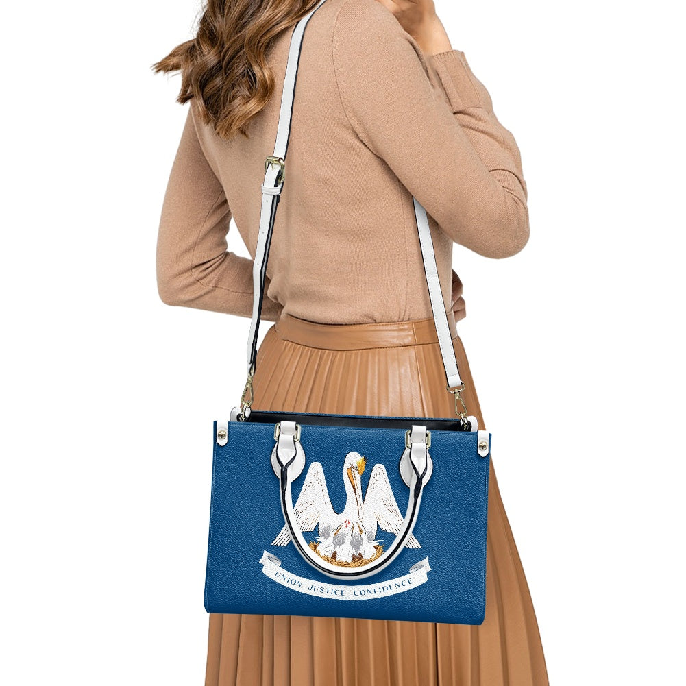 Woman holding [Brand] handbag with pelican design, stylish outfit.