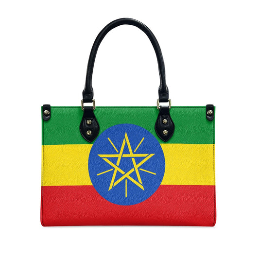 A [Brand] handbag featuring an Ethiopian flag design pattern.