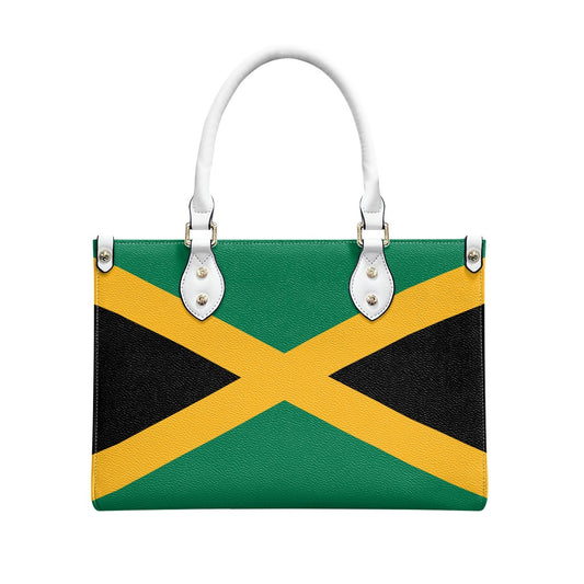 [Brand] handbag featuring Jamaican flag design with white handles.