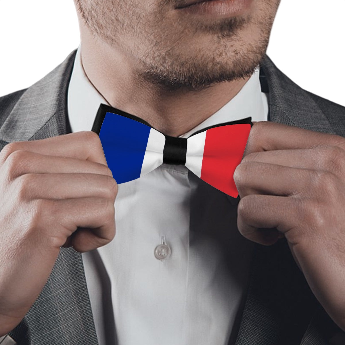 A man adjusting [Brand] bow tie with French flag design.