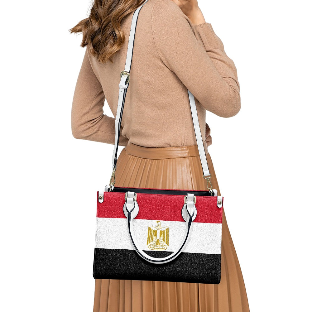 Woman wearing [Brand] bag with Egyptian flag design.