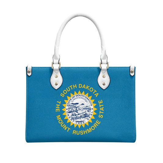 Blue handbag with South Dakota emblem, white handles, [Brand].