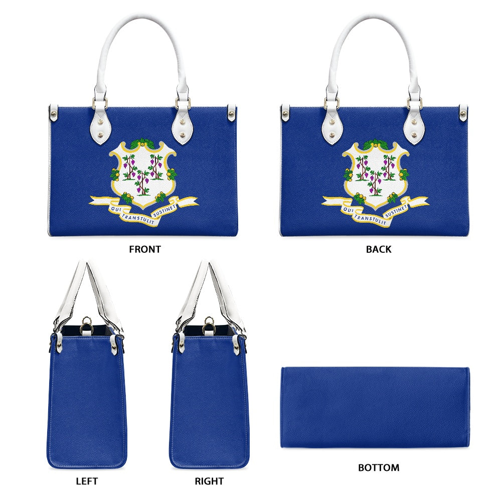 Blue [Brand] purse displaying colorful floral emblem and handles.