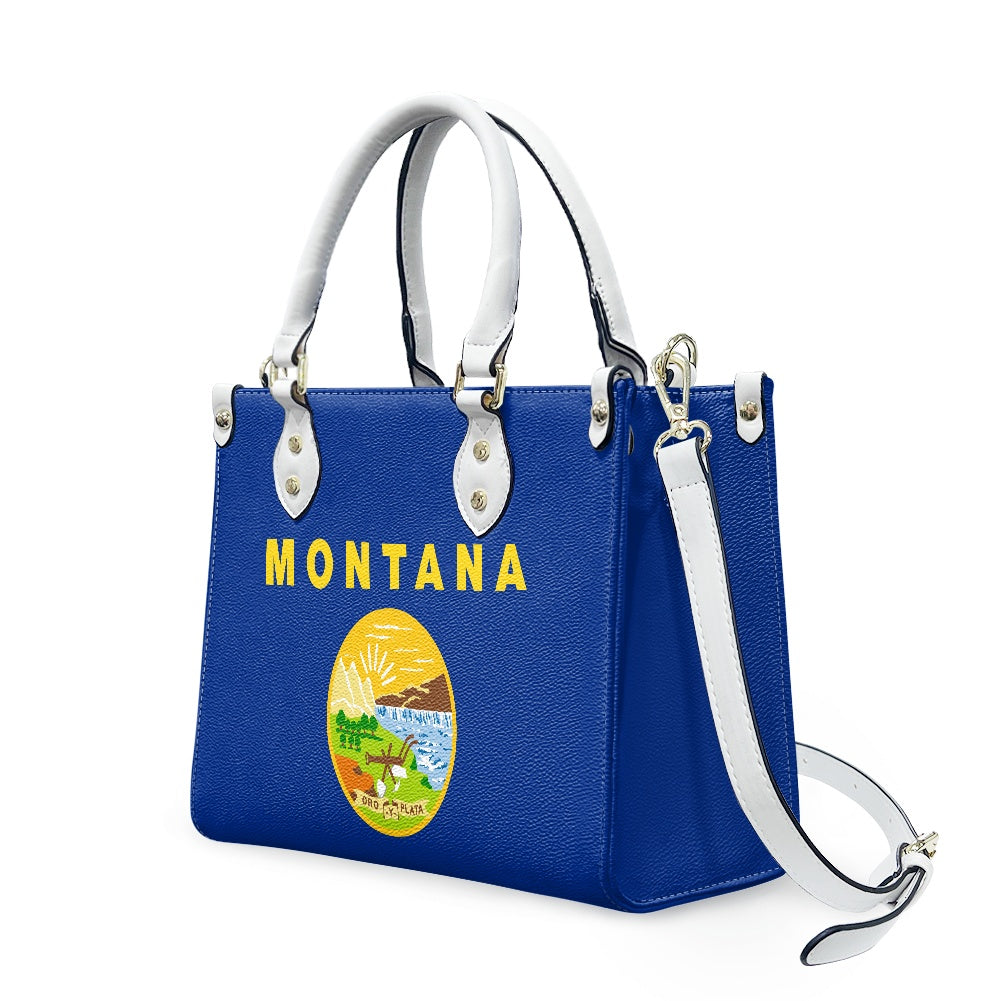 Blue handbag with "Montana" design, white handles. [Brand]